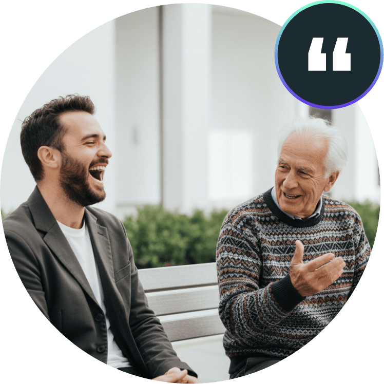 day_care_services_testimonial — A young man and an elderly man laughing and enjoying conversation together outdoors, representing a day care services testimonial