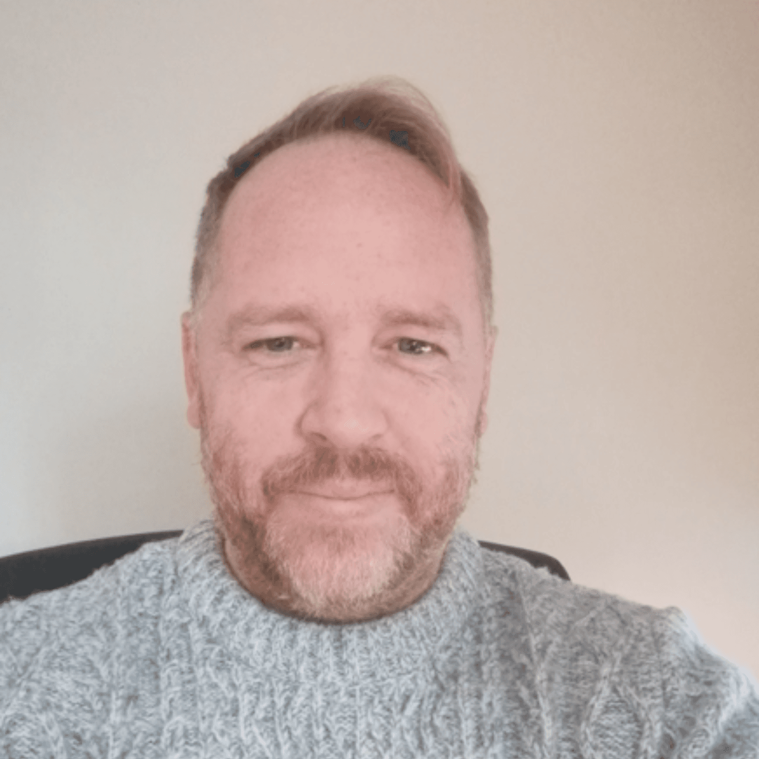 Professional headshot of Adam Walker against a neutral background