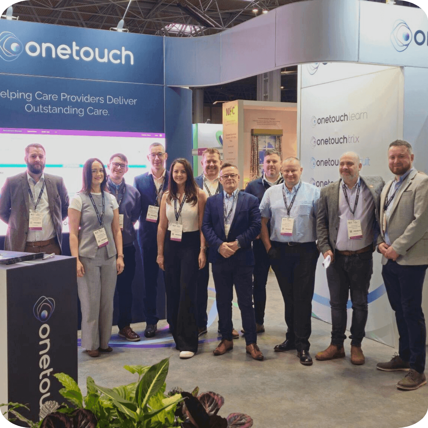 OneTouch team group photo taken at the Care Show Birmingham 2025 event, used on careers page